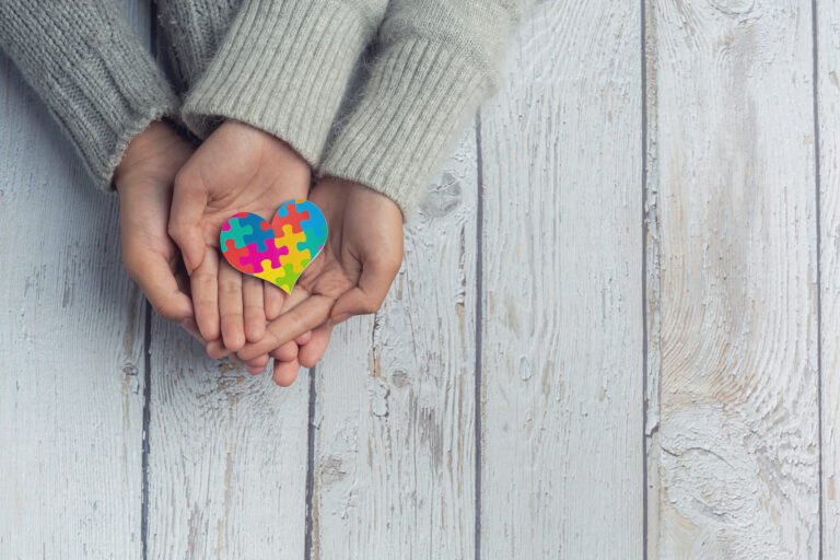 Closeup on two young lovers holding hands at a table